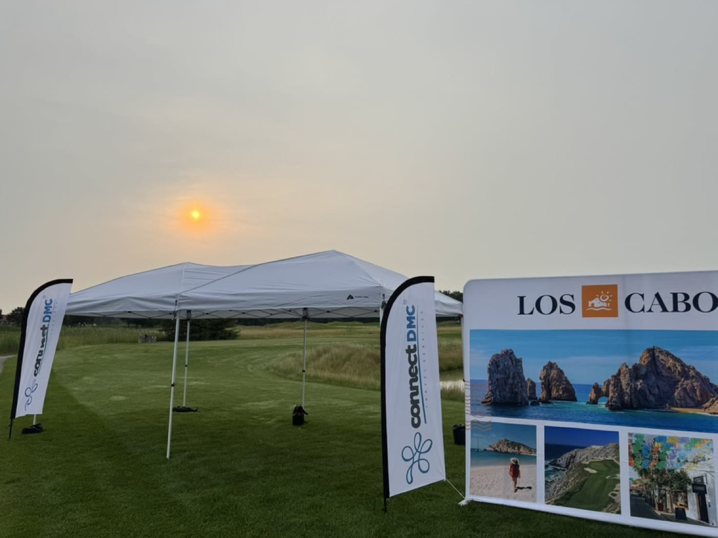 Connect DMC feather flags at an outdoor travel event
